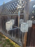 Full view of chrome chandelier with five crystal shades