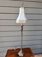 Full view of floor lamp standing on table