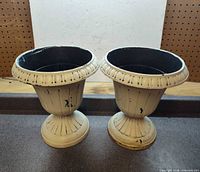 Front view of both matching plastic urn planters