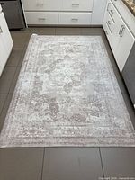 Full view of beige area rug on floor
