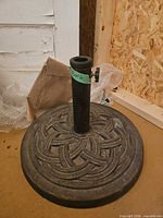 Overall view of umbrella base showing pattern and pole sleeve