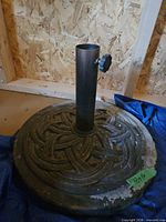 Overall view of cast iron umbrella base with pole holder and tightening knob