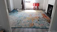 Full view of rug in room showing size and abstract multicolour design