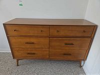 Front angled view showing full dresser, hardware, and legs