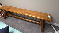 full bench side view showing honey stained finish and log legs