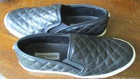 Side-by-side view of both sneakers showing quilted uppers and overall condition