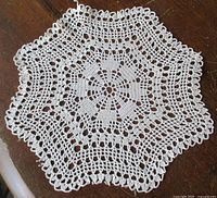 Full view of hexagonal scalloped crochet doily