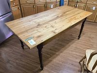 Full view of rectangular farmhouse dining table with turned legs in kitchen setting