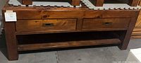 Front view showing two drawers with brass pulls and open lower shelf
