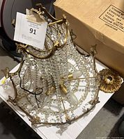 Chandelier body showing frame, lights, crystal strands