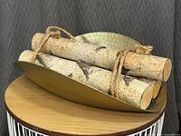 Log holder with birch logs displayed