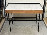 Front view of Structube desk showing faux marble top, drawers, metal frame