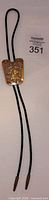 Front view of bolo tie showing slide with horse head and cord