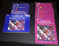 Blue cover Christmas Kaleidoscope I and magenta cover Christmas Kaleidoscope II parts laid out