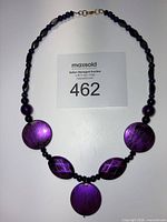 Full view of necklace laid flat showing bead pattern and clasp