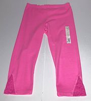 Front view of hot pink capri leggings showing lace insets and tag attached