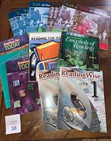 All books spread on table showing titles and quantities