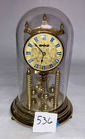 Front view of Welby torsion clock under dome