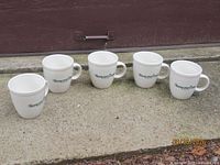 Front view of five mugs lined up