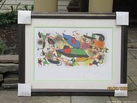 Full view of framed lithograph with protective corner covers