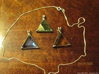 Overview of three pendants with sterling silver chain