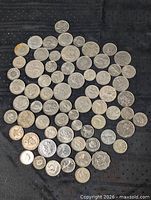All coins spread on black cloth, full lot view