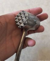 Close-up of tenderizer head showing pyramidal points