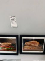 Both framed sandwich prints side by side