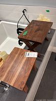 Pair of solid wood tray tables on tub ledge