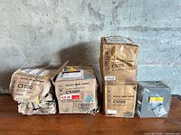 Four Ricoh toner cartridge packages on table