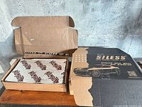 Two open boxes showing Siless packaging and Kilmat sheet inside separate box