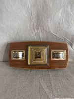 Front view showing entire wooden weather station with three gauges