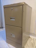 Front view showing two drawers, lock, beige paint