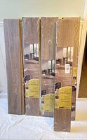 Front view of four sealed boxes and loose planks showing product
