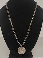 Full view of necklace on display bust showing chain style and pendant placement