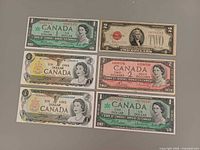 All six notes laid out showing denominations and designs