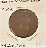 Token obverse in holder with handwritten identification
