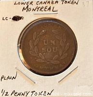 Coin in flip showing wreath side with UN SOU