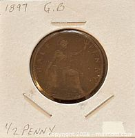 Full view of coin in flip showing reverse seated Britannia