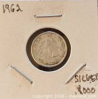Coin in 2x2 flip showing reverse with Bluenose schooner and date 1962