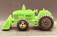 Left side view of green Hot Wheels tractor with front bucket