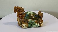 Left side view showing dragon head, shell, and wave base