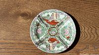 Front view of porcelain plate showing complete Famille Rose decoration