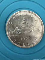 Reverse of 1966 Canada silver dollar showing Voyageur design and date