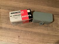 Box labeled BounceMaster Model BC Fanflash and grey hard case