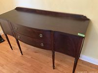 Full view of dark wood serpentine front sideboard