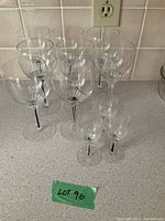All 11 stemmed clear glasses arranged on countertop