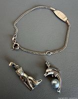 Bracelet and two pendants laid out showing overall design and scale