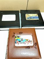 Three photo albums laid out showing covers