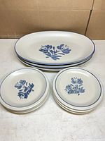 Stacked platters and plates showing pattern and quantity